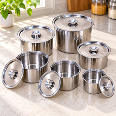 Six open stainless steel storage containers in graduated sizes