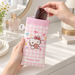 Sunglasses being placed into pink kitty glasses pouch