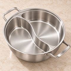 Empty cooking pot showing the curved divider and side handles