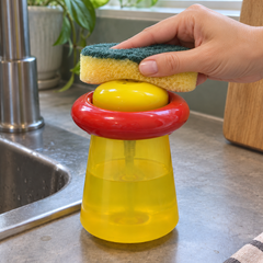 Hand holding sponge above soap dispenser