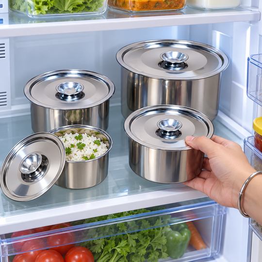 Covered steel food container being placed inside a refrigerator