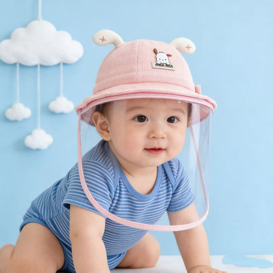 Baby wearing pink face shield hat with striped outfit