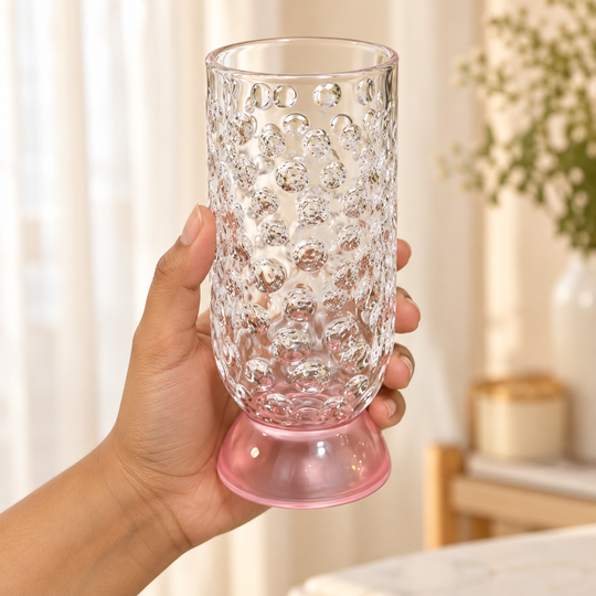 One hand holding the empty Bubble Drinking Glass for scale