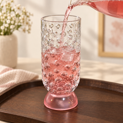 Pink sharbat poured into Bubble Drinking Glass on a serving tray