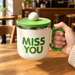Green Cozy Sip Mug held by its matching handle