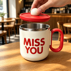 Red Cozy Sip Mug with lid lifted by the round knob