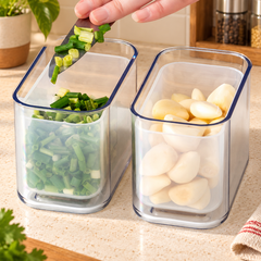 Open flip-lid drain basket containers with spring onion and garlic