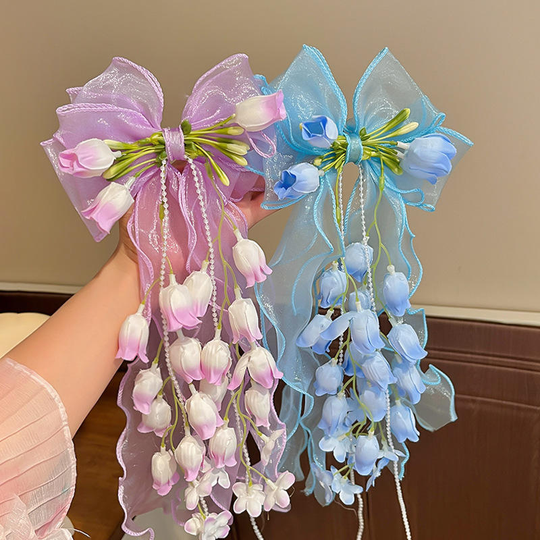 Pink and blue Floral Bow Curtain Clips showing bows, hanging flowers and pearl-look strands