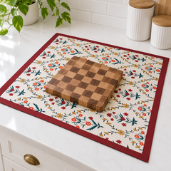 Mat beneath a chopping board on a counter