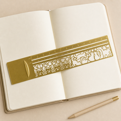 Kitty Sketch Ruler styled on an open notebook