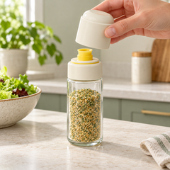 Removable cream outer cap lifted from seasoning bottle